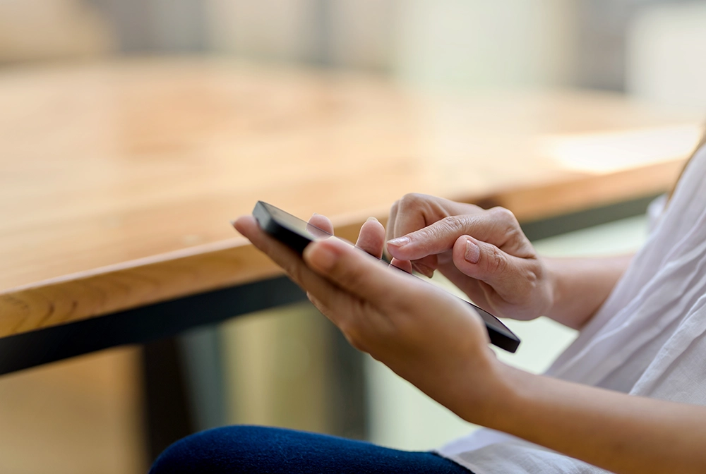 Close up. Woman hand using smartphone order goods online.